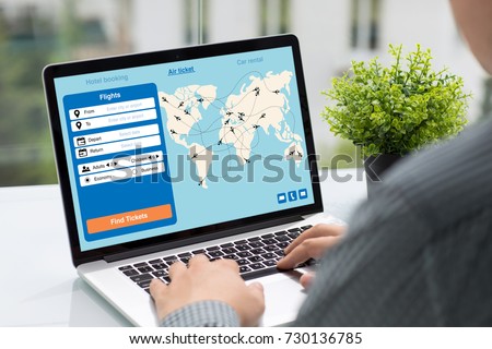 Man holding computer with application search air ticket screen in street cafe