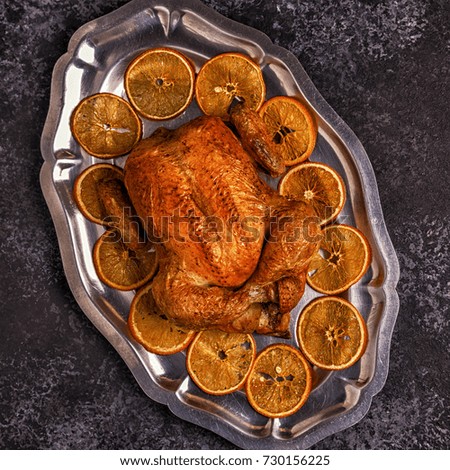 Roasted whole chicken with Christmas decoration. Top view, copy space.