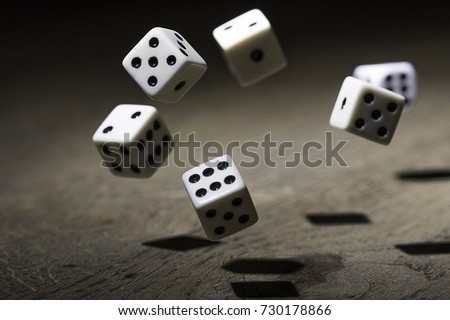 Let`s play a diced game. Dice in mid air  Royalty-Free Stock Photo #730178866