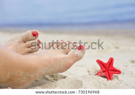 Picture of beautiful female legs on sea background Starfish