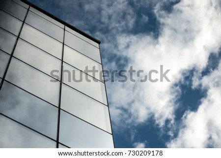 Building with glass reflecting clouds