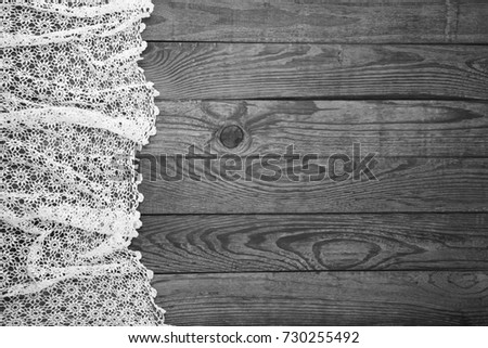 Old vintage wooden table with checkered tablecloth. Top view mock up. Black and white photo.