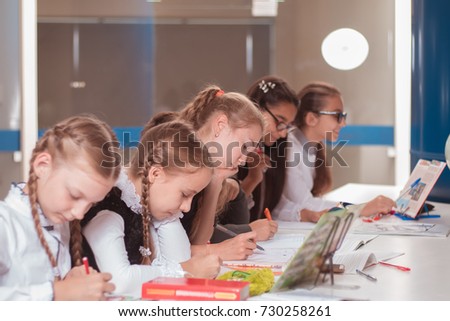 classes in creative children's school, girls and boys posing