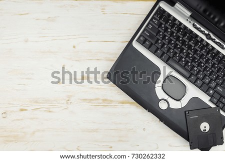 old laptop keyboard with floppy disk