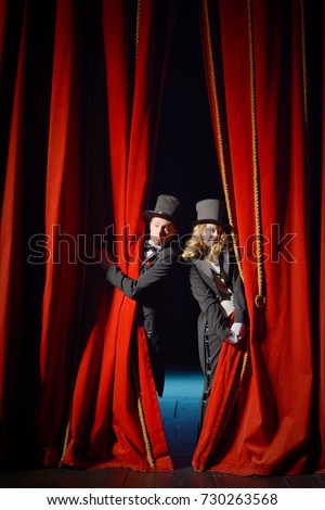 the actor opens a theater curtain Royalty-Free Stock Photo #730263568