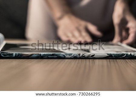 Close up of woman looking at picture in photo album.