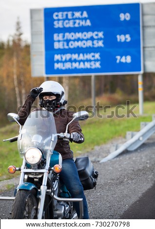 Young woman travels on motorcycle in northern part of Russia. The Kola route to Murmansk city