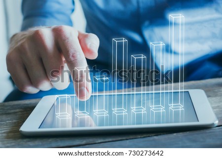 business analytics and financial technology concept, 3d chart from the screen of digital tablet computer Royalty-Free Stock Photo #730273642