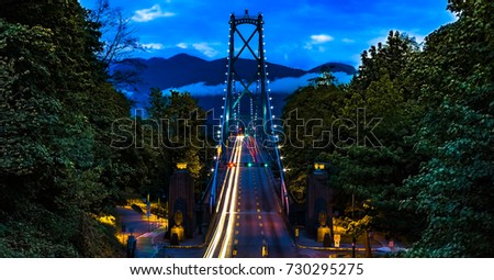 Vancouver, British Columbia. Canada View from above of the Lions Gate Bridge with lights trail, glitters and clouds. 