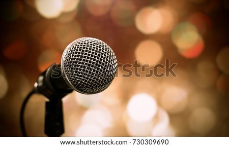 Blurred of microphones in seminar room, talking speech in conference hall light with microphone and keynote. Speech is vocalized form of communication humans.