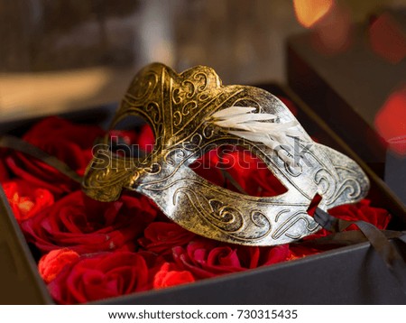 mask and rose in box
