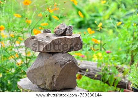 Zen stone on flowers background.