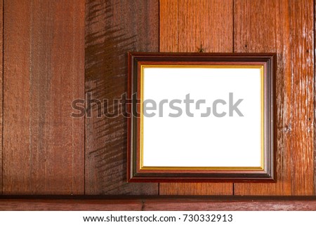 blank photo frame hanging on wooden wall background, copyspace. Clipping path