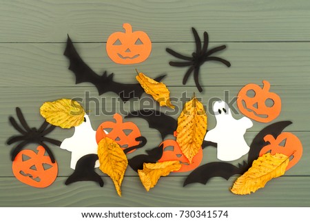 Paper silhouettes of Halloween characters with decorative pumpkins, spiders and ghosts on gray background. Halloween concept