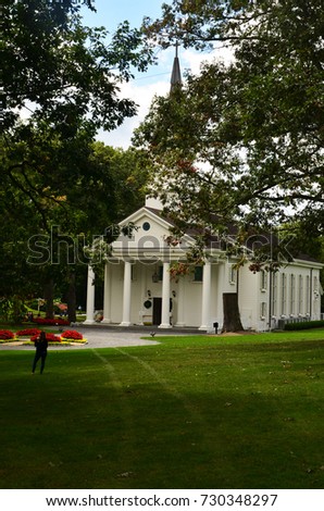 Woman takes picture of a church at Greenbrier West Virginia