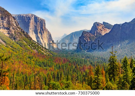 Tunnel View of scenic Yosemite Valley with famous El Capitan, Half Dome rock climbing summits, and and Bridalveil Fall in summer, Yosemite National Park, California, United State of America Royalty-Free Stock Photo #730375000