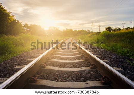 Railway tracks with sunset background. Royalty-Free Stock Photo #730387846