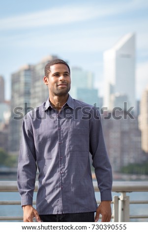 Portrait of young handsome African American man with NYC skyline in the background, photographed in September 2017