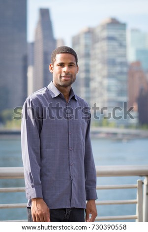Portrait of young handsome African American man with NYC skyline in the background, photographed in September 2017