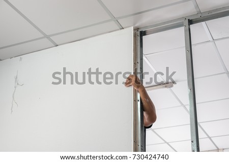 Workers dismantled wood, partitioning the wall and ceiling Royalty-Free Stock Photo #730424740