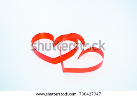 Heart shaped red stickers on the background.