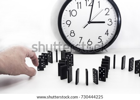 Falling domino abstraction. Black domino isolated on white background.