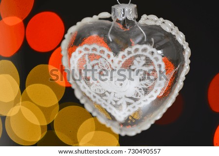 A hanging christmas heart ball with bokeh background