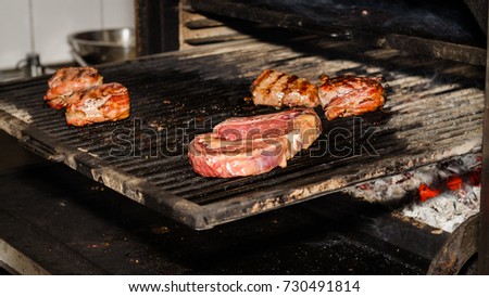 Meat and vegetables are roasted for guests on the grill