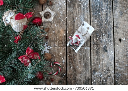 Christmas wooden background with branches of Christmas tree and Christmas decorations with snow. Christmas design. Copy space
