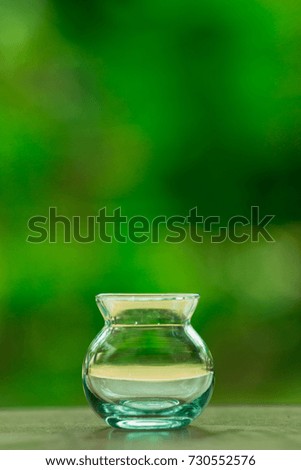 empty jar on green background.free space