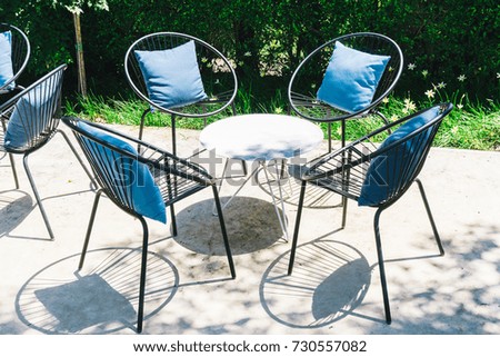 Patio with Pillow on chair and table set in outdoor garden