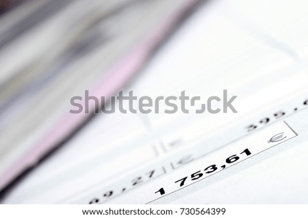 Part of a payroll with focus on black figures and blur around on the other paper sheets