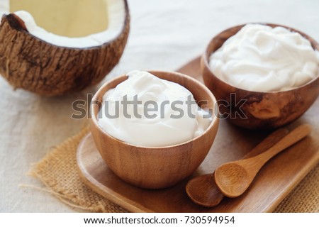 organic coconut yogurt in wooden bowl, dairy free yogurt, probiotic food, gut health, keto, ketogenic, low carb diet, sugar free,  gluten free dessert Royalty-Free Stock Photo #730594954