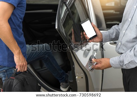 traveler or tourists go in to the car driver use smart phone from taxi  car sharing with white mobile phone screen with  clipping path Royalty-Free Stock Photo #730598692