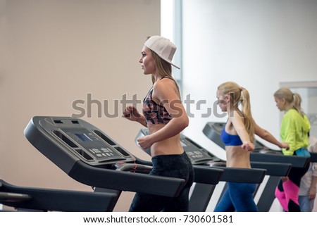 People running on treadmill at gym