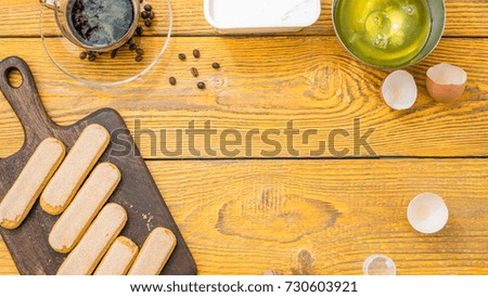 Photo on top of table with savoyardi cookies, coffee, cream cheese. Place for text