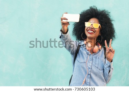 Self portrait of beautiful young afro american woman making peace sign. Selfie Concept.