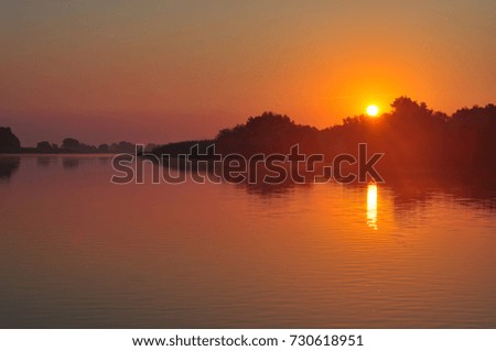 sunrise on the river, at Danube Delta, Romania