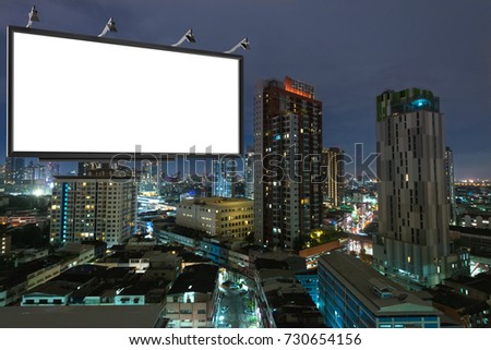 Blank billboard on buildings, street and urban in the night. Advertisement for display or montage product or business