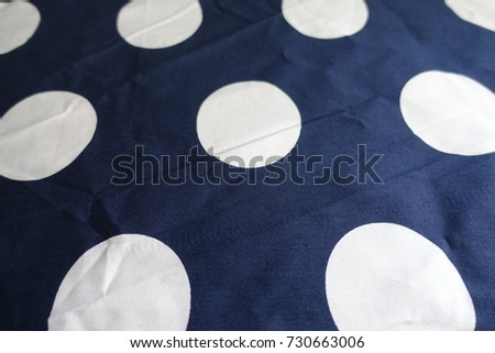White spots on jammed dark blue cotton fabric