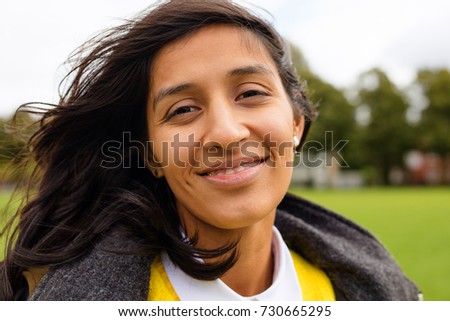 young woman smiling in the park