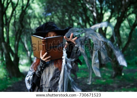 Image of witch with magic book