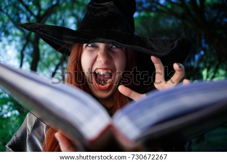 Close-up photo of witch reading spell