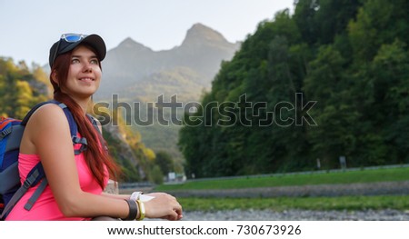 Image of tourist woman with backpack backdrop of mountains