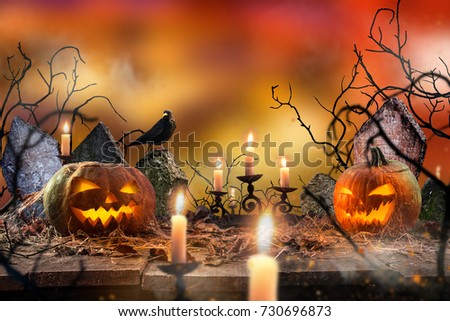 Spooky Halloween pumpkins on wooden planks with spooky background.