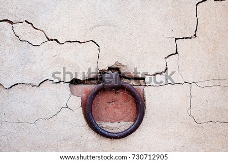 Ring in the old wall. Metal hoop in the wall.