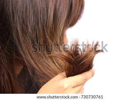 Woman holding her long hairs that make color treatments. The hairs maybe have problem (split end) .Should care or cut end of hairs. On white background Royalty-Free Stock Photo #730730761