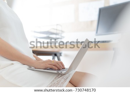 Business woman using a laptop computer at office