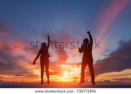 Silhouette of happy two business people making high hands in sunset sky background for business teamwork concept