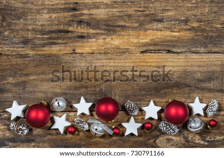 Christmas border with traditional ornaments on wooden background with copy space.